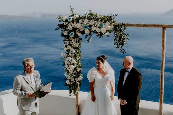 Summer Wedding In Oia With A Lush Floral Arch