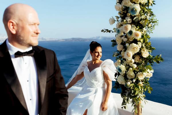 Summer Wedding In Oia With A Lush Floral Arch