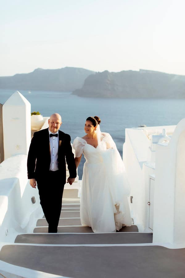 Summer Wedding In Oia With A Lush Floral Arch