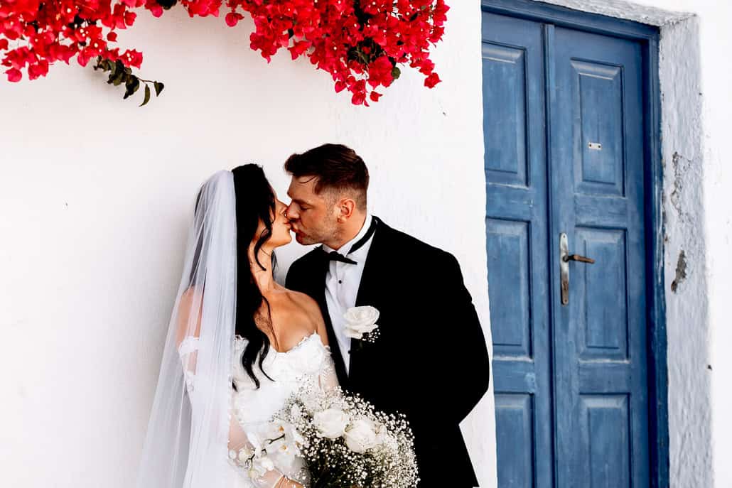 Modern Santorini ceremony on the cliffs with a view of the caldera | Kelci & Alex