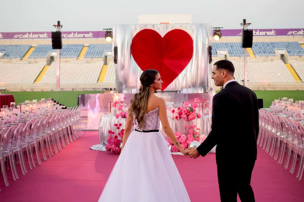 Fashion-forward stadium wedding with vibrant disco style | Charis & Giorgos